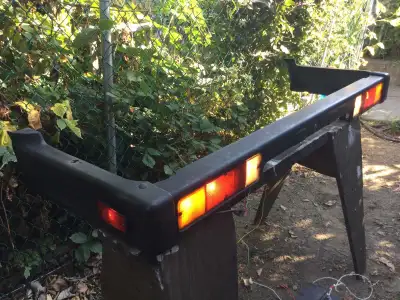 Complete, OEM rear bumper and light housings for a 1987 Suzuki Samurai. Broken light cover on right...