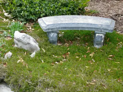 Concrete garden bench. Measures 39" (99 cm) long, 16" ( 40 cm) high. The seat is 13" wide. The seat...
