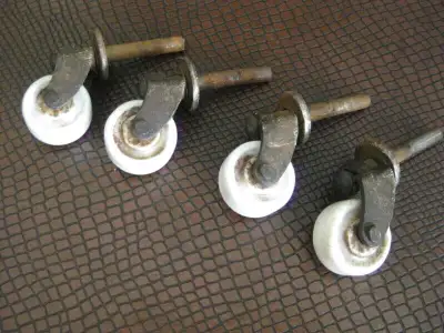 Set of 4 small, porcelain caster wheels. These casters are off a small side table which was made in...