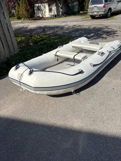 Inflatable 10.5ft dinghy boat. Quicksilver off white PVC - 4-5 person. Attached wheels for easy mobi...
