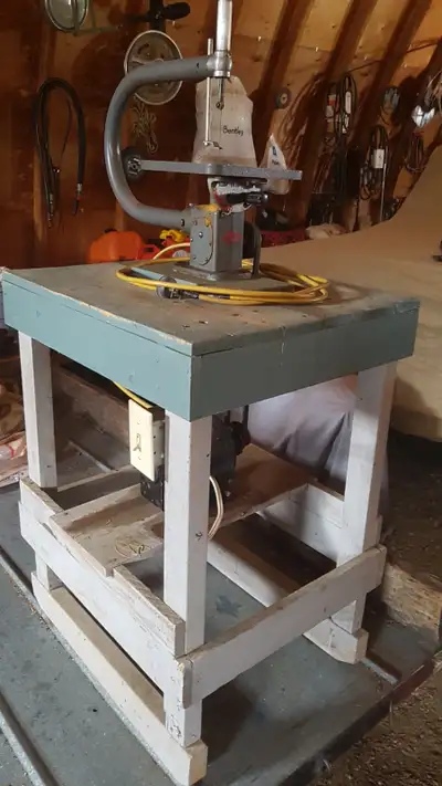 Craftmaster scroll saw powered by 1/4 hp electric motor mounted on a wooden stand.