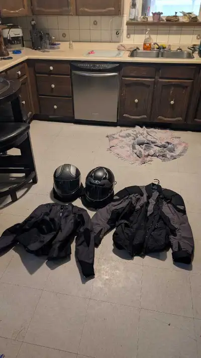 This motorcycle gear set includes two helmets and two jackets, offering comprehensive protection for...