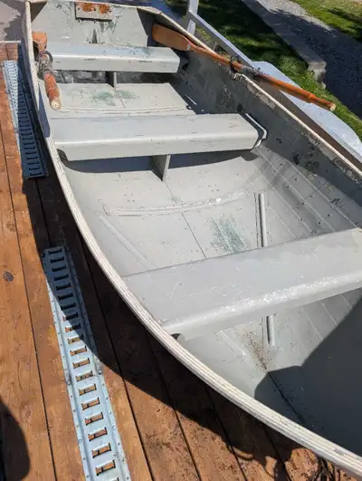 12 Foot Aluminum boat, which comes equipped with oars, and a Johnson 7.5 (2 Stroke) motor, and marin...