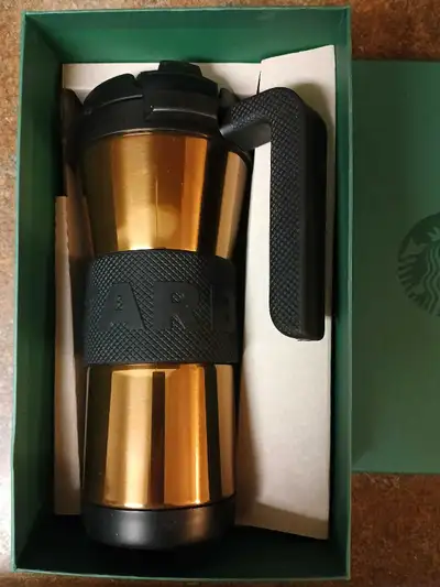 This is a Starbucks travel mug, new, never used, perfect for coffee or tea on the go, appearing with...