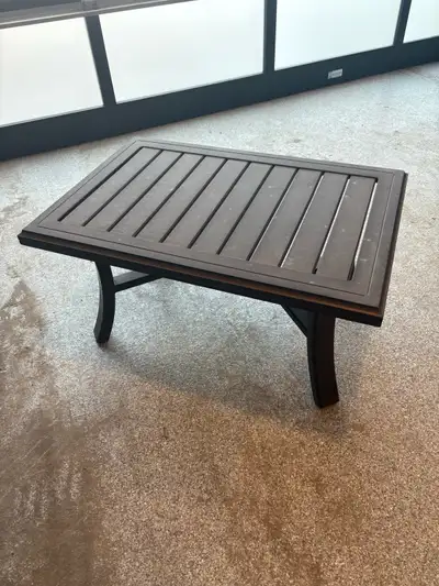 Dark brown aluminum coffee table. Great condition. 3’ x 2’