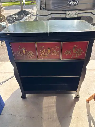 This unique black bar cabinet is not just a piece of furniture; it's a conversation starter, featuri...