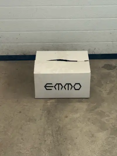 This is an excellent condition, pre-owned Emmo 310 helmet in size XXS, featuring a sleek black finis...
