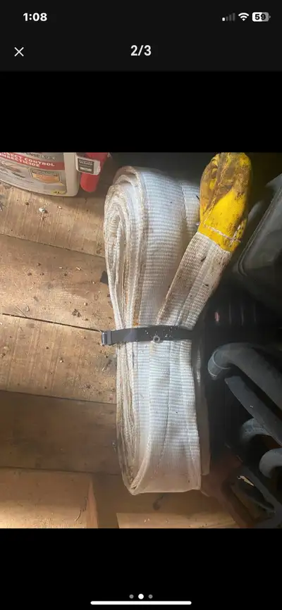This heavy-duty tow strap is designed for reliable vehicle recovery, featuring robust construction a...