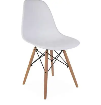 This modern Eames-inspired dining chair features a durable white molded seat shell supported by stur...