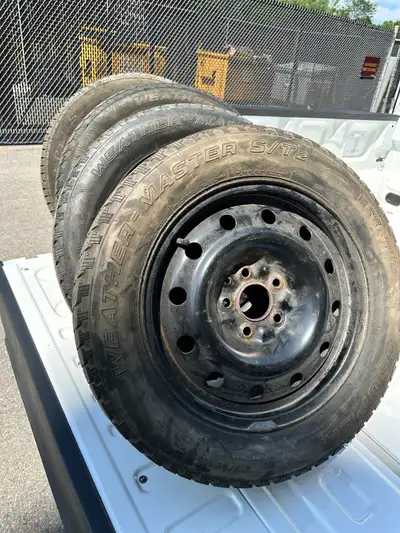 Four winter rims with winter tires, one rubber is new, one is on its last legs, other two in between...