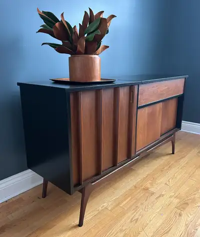 This unique Mid-Century Credenza Bar is beyond fabulous! The frame has been painted sleek black to r...