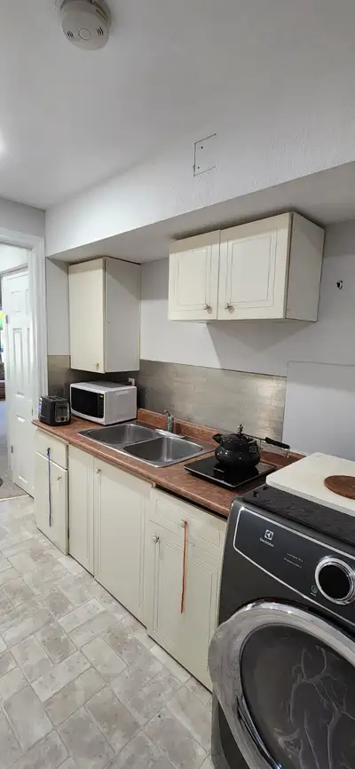 walkout basement with Kitchen and attached washroom. Furnished with Queen bed and a mattress, 3 seat...