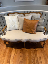Loveseat with wood accents and grey/sand fabric  