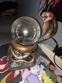 Cobra snake on skull base electric sphere.