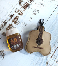 Guitar shaped hand sanitizer holder