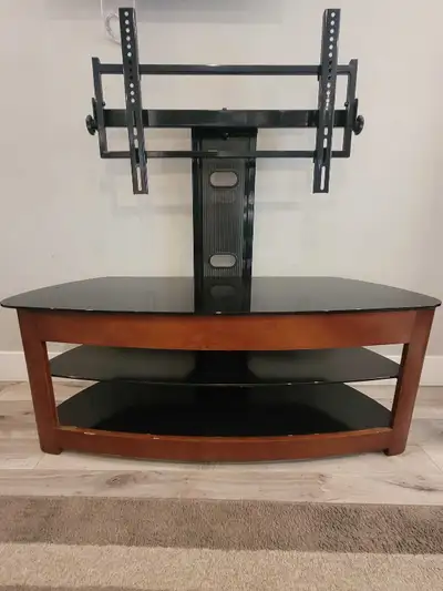 TV stand featuring three tempered glass shelves and a sturdy integrated metal mount. This unit allow...