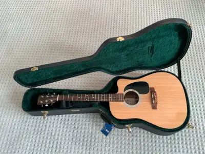 For sale is a Martin DC1E acoustic-electric guitar, featuring Fishman electronics and a cutaway desi...