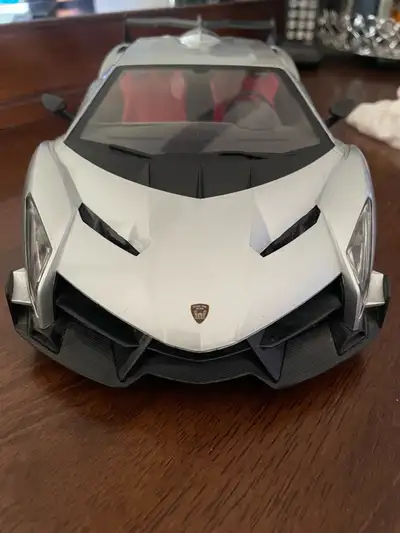 Lamborghini Rc Car, battery powered, comes with charger. Has working head and tail lights, has opena...