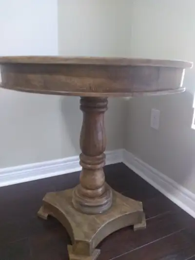 Solid wood dining table with two upholstered grey chairs, View more