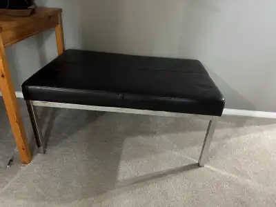 Black faux-leather bench/ottoman, padded bench with metal legs., View more