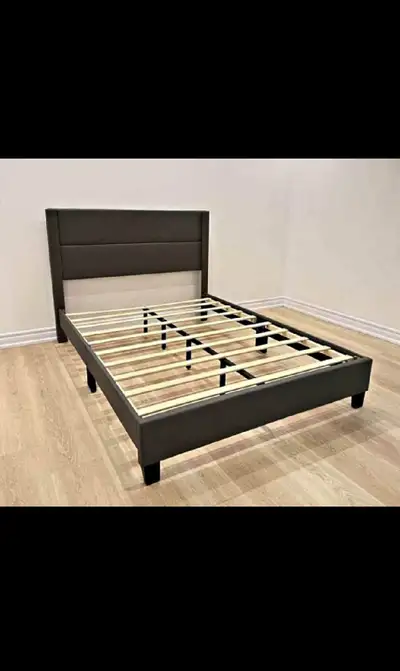 This is a used queen bed frame featuring a modern design with a faux leather headboard and sturdy wo...