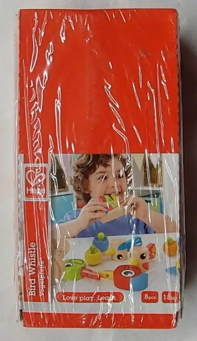 New and sealed but part of shrink wrap has wrinkles. Hape Bird Whistle 8pcs in wooden case Package W...