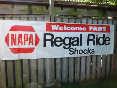 Vintage NAPA Regal Ride Shock "Welcome Fans" vinyl banner, approx 3' by 10', backside has some paint...