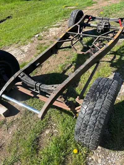 Dropped front axle on split bones. Boxed original frame rails with square tube center crossmember, m...
