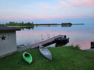 This waterfront cottage is a large four season family residence located in a quiet bay with pictures...