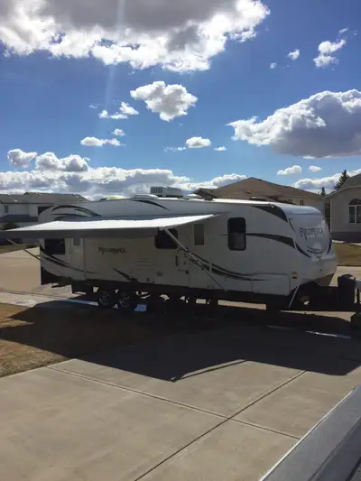 2014 Razorback 2950 travel trailer toy hauler: - Happijac Electric Bed Lift with Sofa -Onan 4.0 kW G...