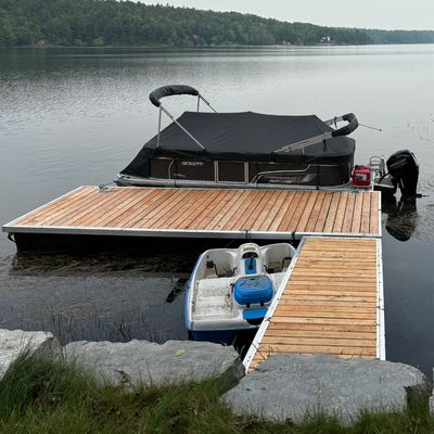Heavy-duty floating dock deck system with pressure-treated decking, designed for Ontario cottages an...