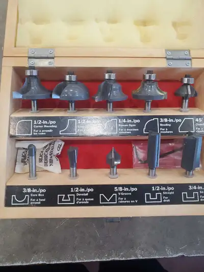 This is a Craftsman router bit set in a wooden case. It includes various bits for different woodwork...
