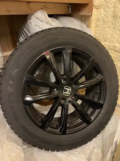 These 235/60R18 (Bridgestone Blizzak DM-V2). come mounted on sleek Honda black alloy rims and are re...