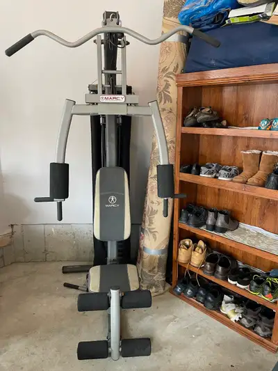 Marcy Home Gym in good condition. With approximately 150-200 lbs weights. Side Triceps' cable cover...