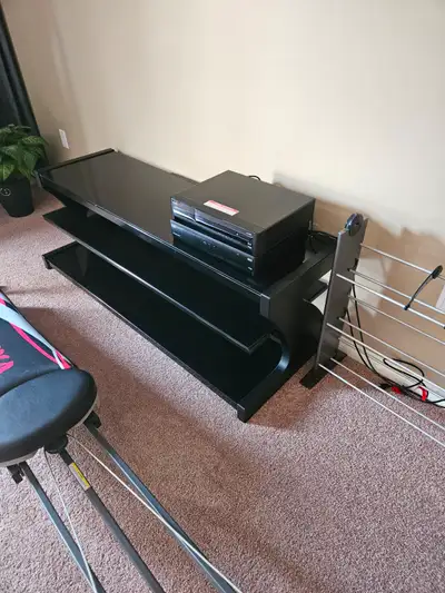 Sturdy 5 Ft long and 21" tall 3 tier TV/ Component stand for sale. The stand is steel framed with bl...