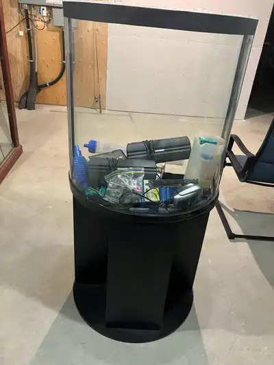 20 Gallon Curved Glass Aquarium on matching stand. Comes with filter, lights, air pump, heater and o...