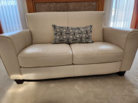 Buttery cream coloured leather love seat