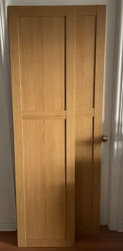 Two Ikea Pax Doors in an oak finish size 50x195 with hinges. Each door features a panel design. Sell...