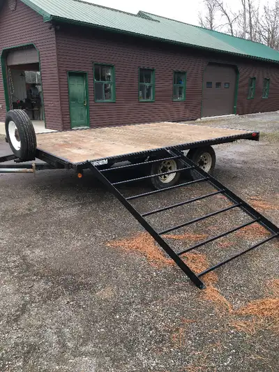 Flat bed double axle trailer. 12 feet x 8 feet. Pressure treated deck. Oil spray undercoated. Movabl...