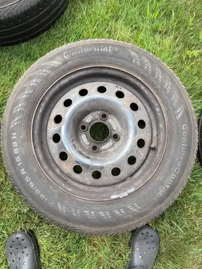 Set of 4 used Continental all-season tires mounted on rims, size P195/65 R15. These came off a 2005-...