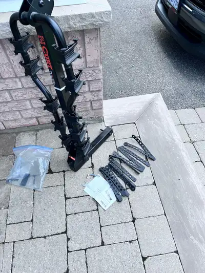 Curt folding bike rack also folds to allow access to trunk, 180 firm.