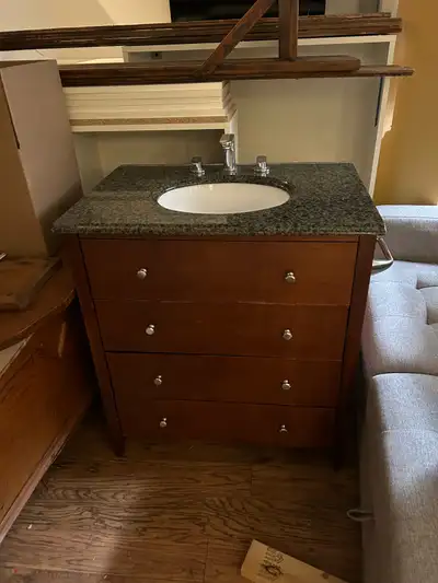 Used bathroom vanity in good condition. 36-inch width and a dark-green and black granite top, with w...