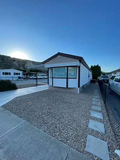 Mobile home in the sought after Caravilla Estates 55+ community. YOU OWN THE LAND! Great corner lot...