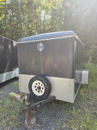This is a used Wells Cargo 6x12 enclosed trailer, perfect for hauling your gear safely and securely....