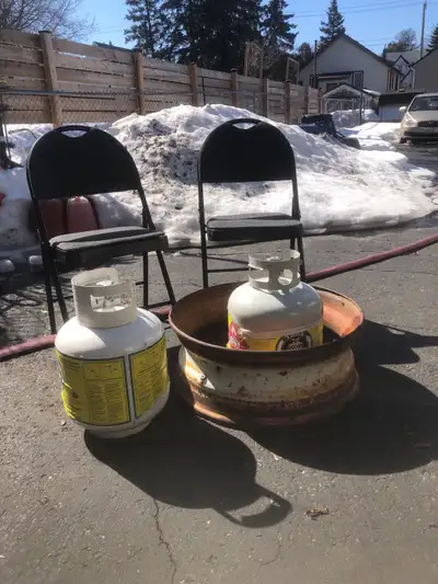 2 chairs, 2 propane tanks and a firepit rim, View more