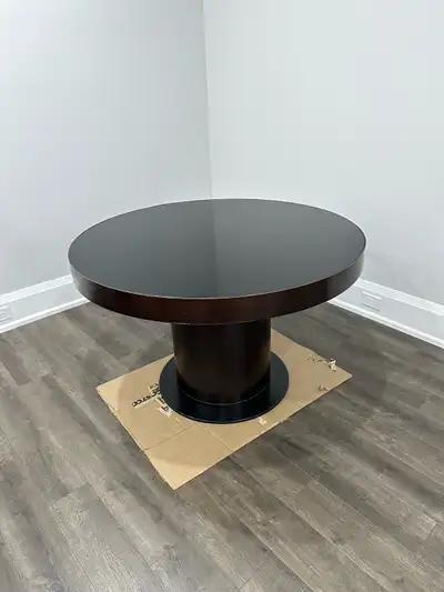 Round espresso brown dining table with glass top. Upper portion unscrews from base for easy transpor...