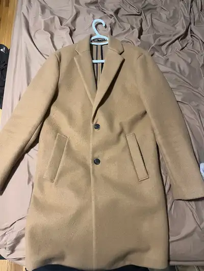 Classic tailored fit, knee-length, two-button closure. Warm and clean look, great for winter or dres...