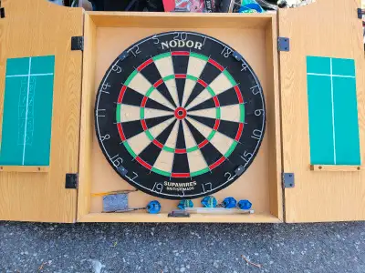 This is a dartboard and cabinet in used but good condition, perfect for some classic pub-style fun a...