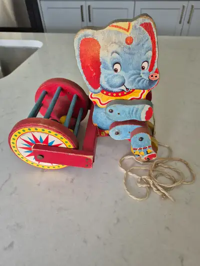 The Fisher Price Elephant (Jumbo) wooden pull toy # 755 is from 1951. The elephant is on a tricycle...