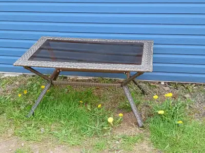 Wicker outdoor coffee table with glass top, must pick up, asking $30.00 Its in great shape, been sto...